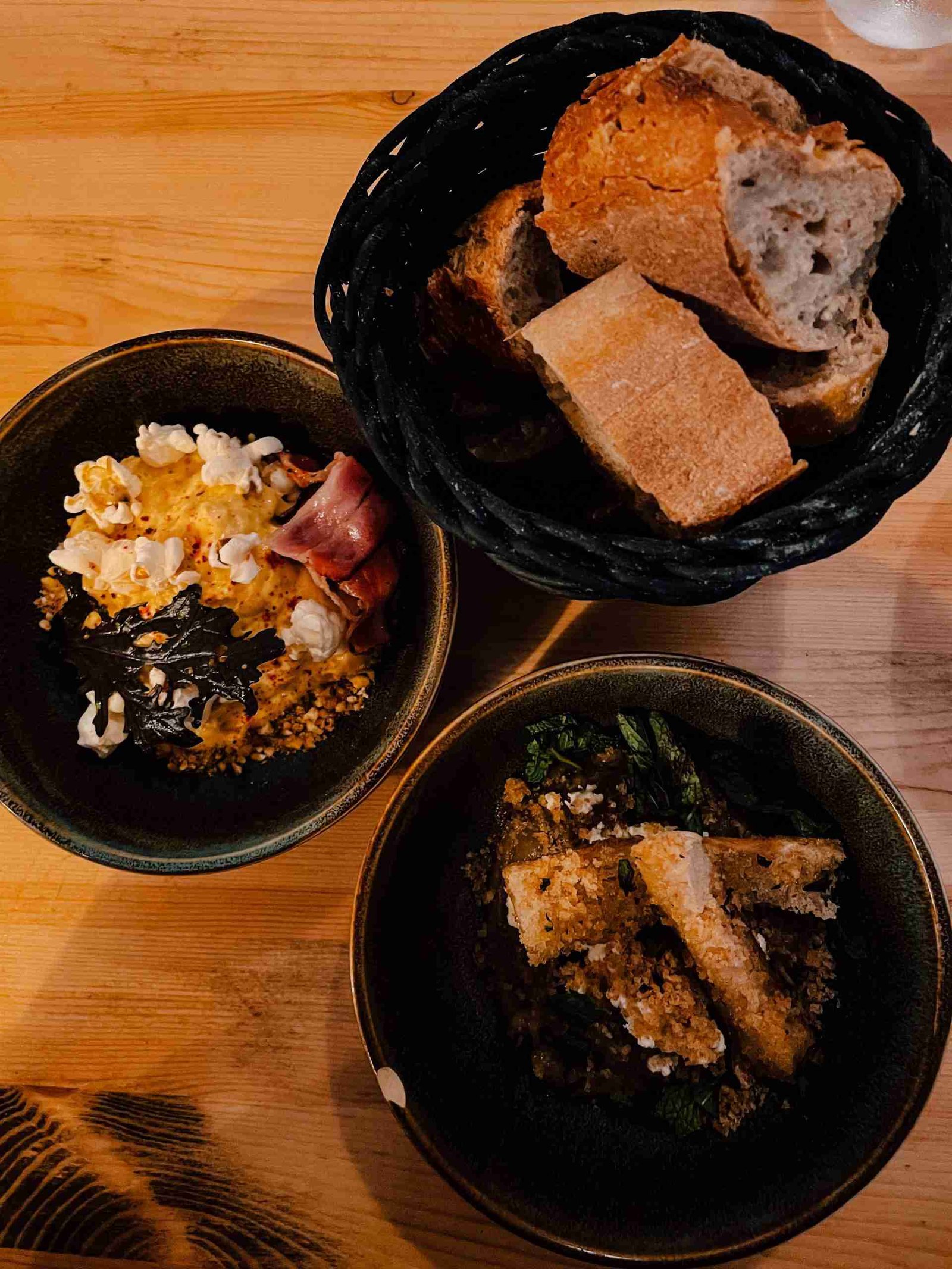 3 bowls of colourful food on a wooden table