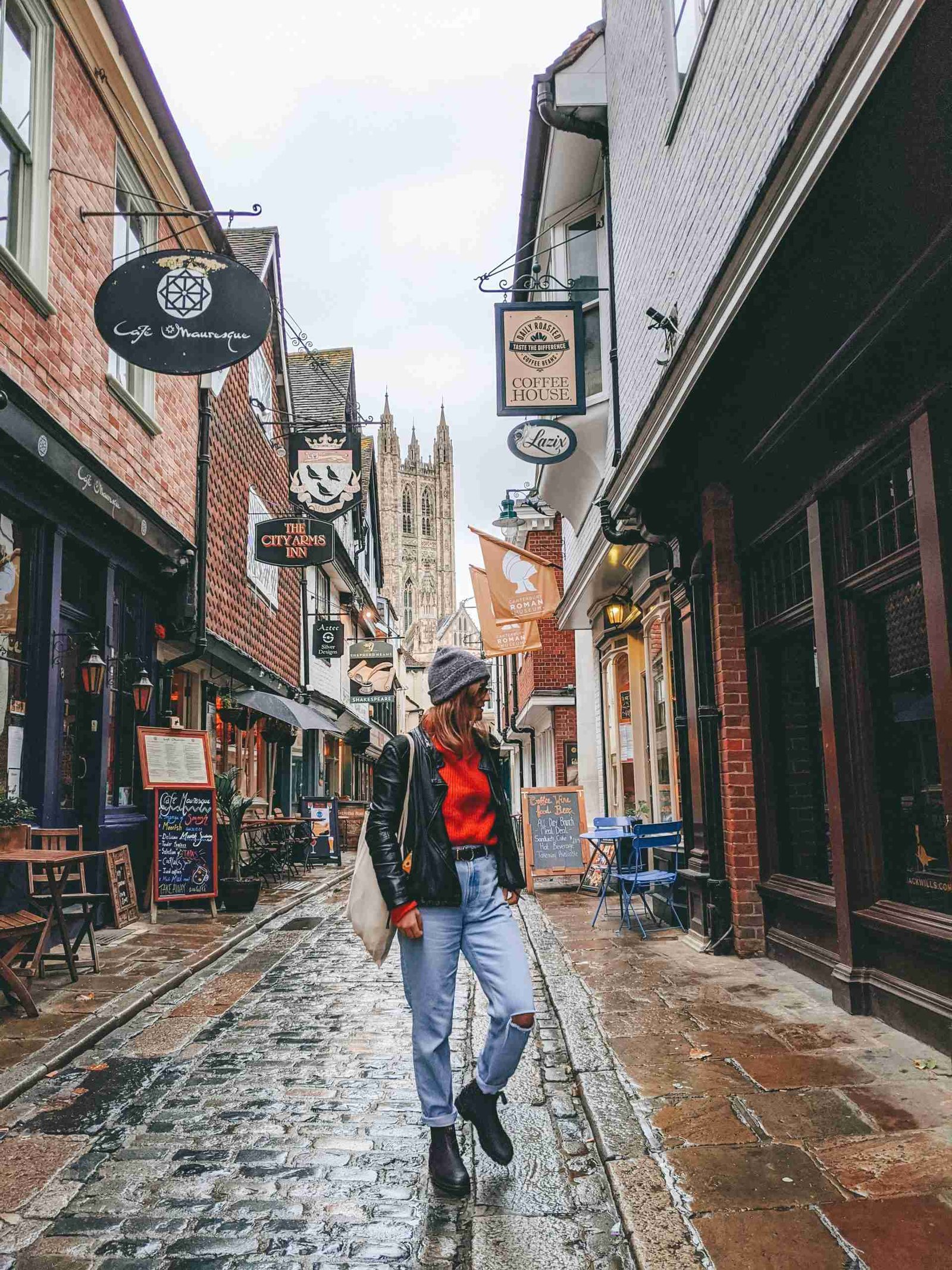 a girl standing in one of the tight streets in Canterbury - an underrated day trip from London