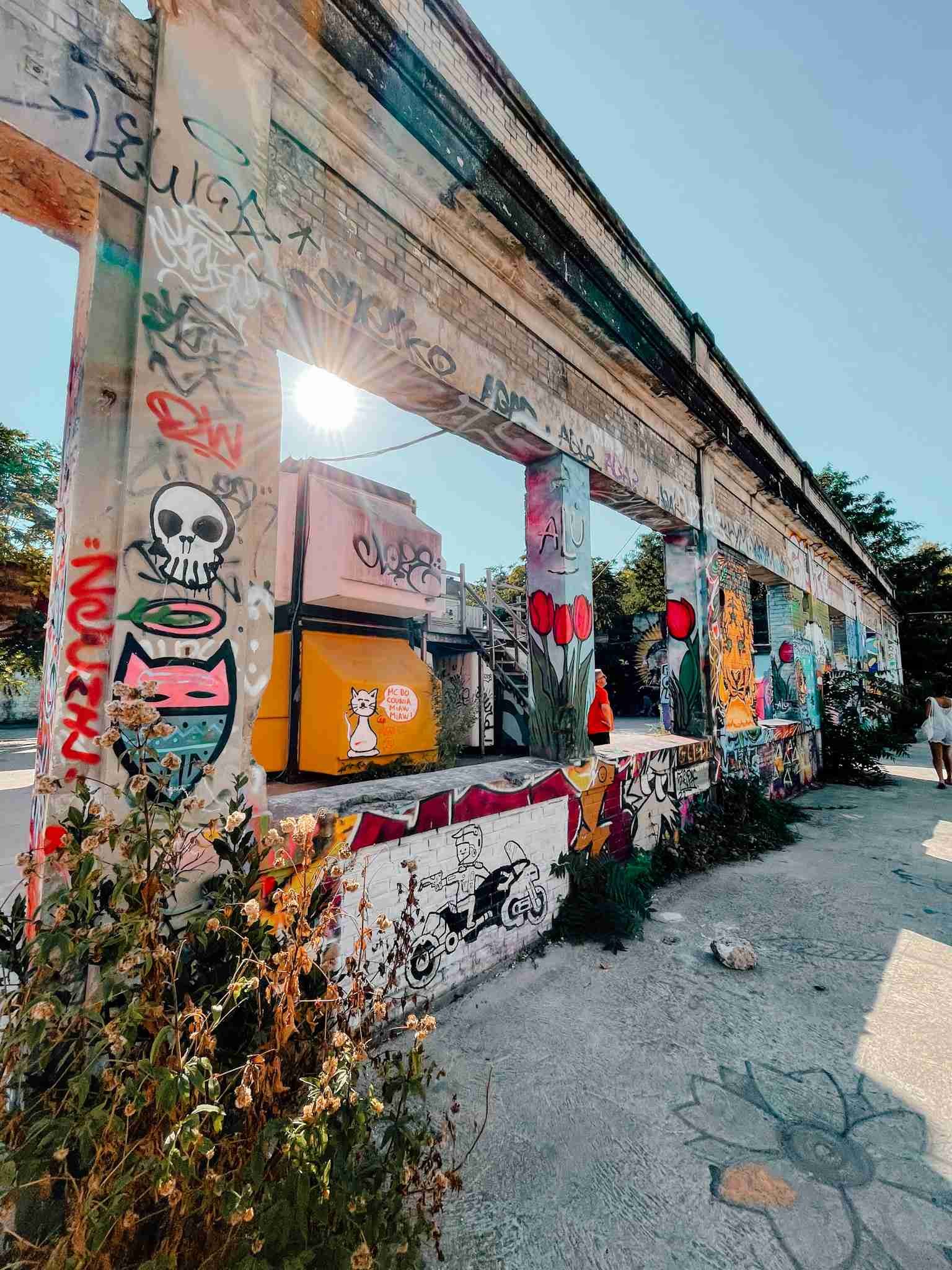 An abandoned building covered in street art