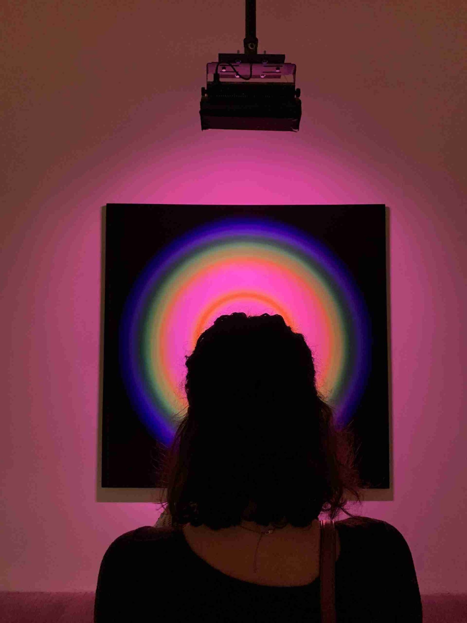 A girl standing in front of one of the art pieces in the Tate Modern, London's museum of modern art