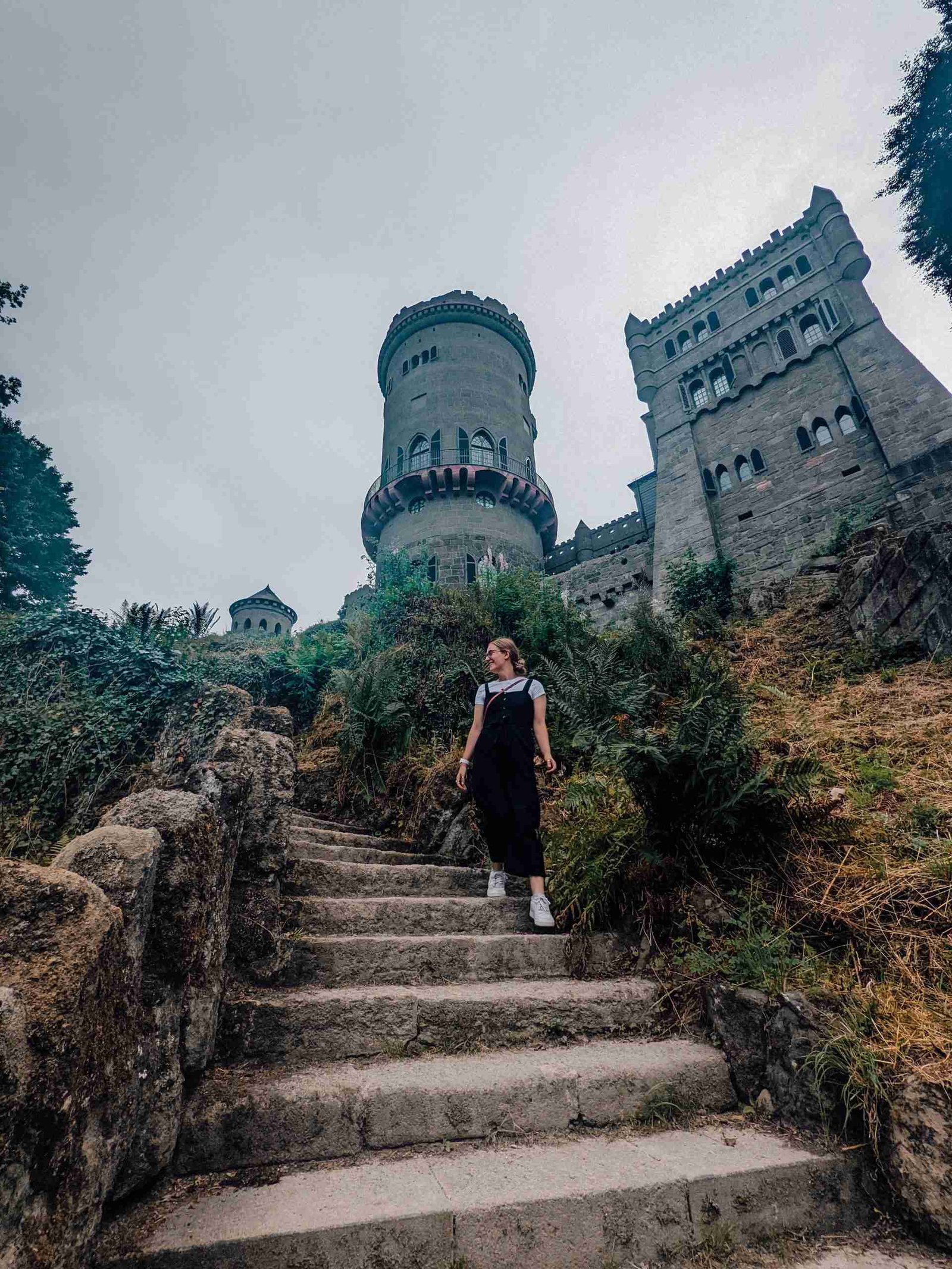 A girl walking down the steps away from the castle ruins inside Bergpark - one of our stops on the German Fairy tale Route