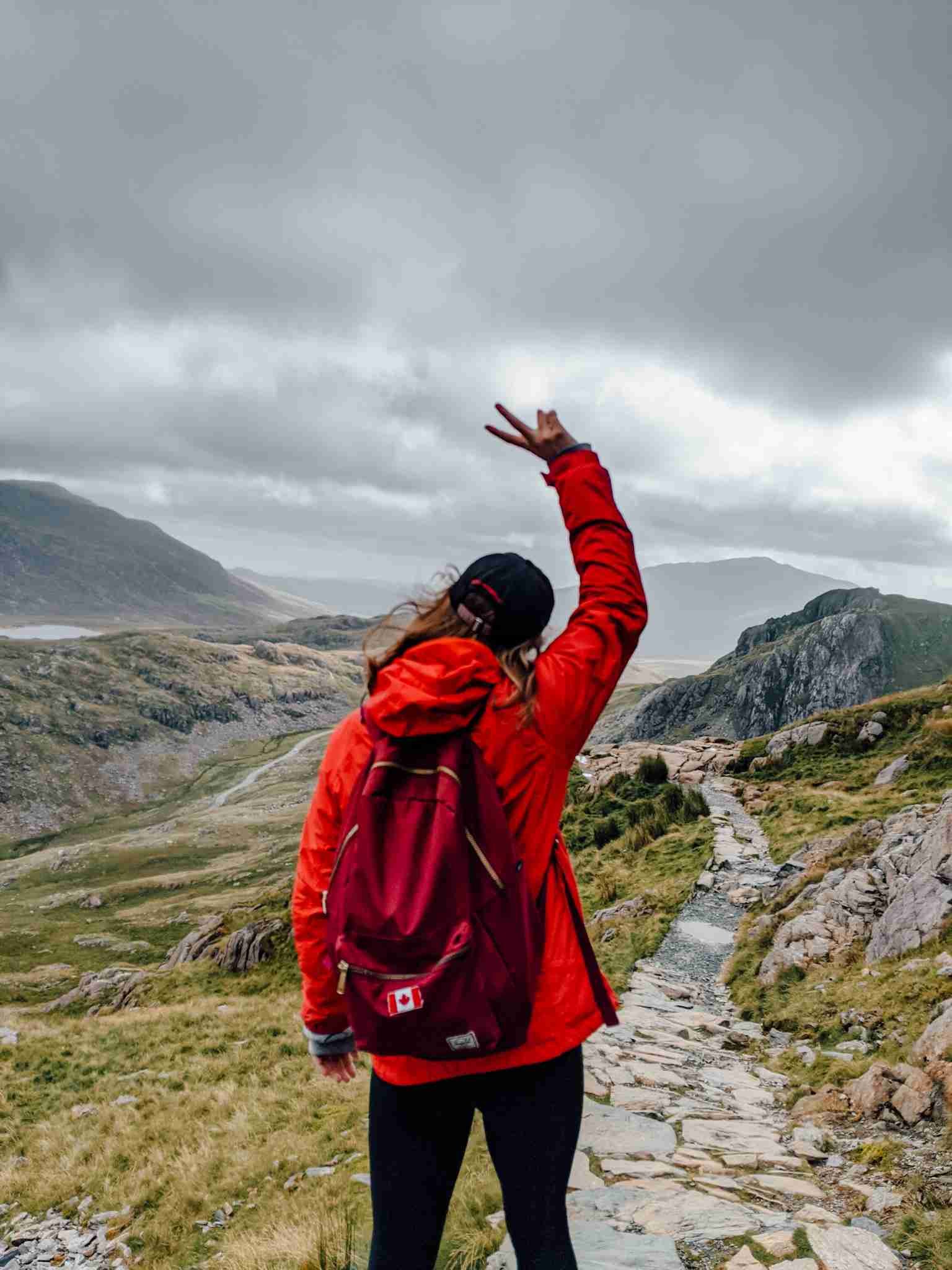 A girl onlooking the winding path on Mount Snowdon in Wales