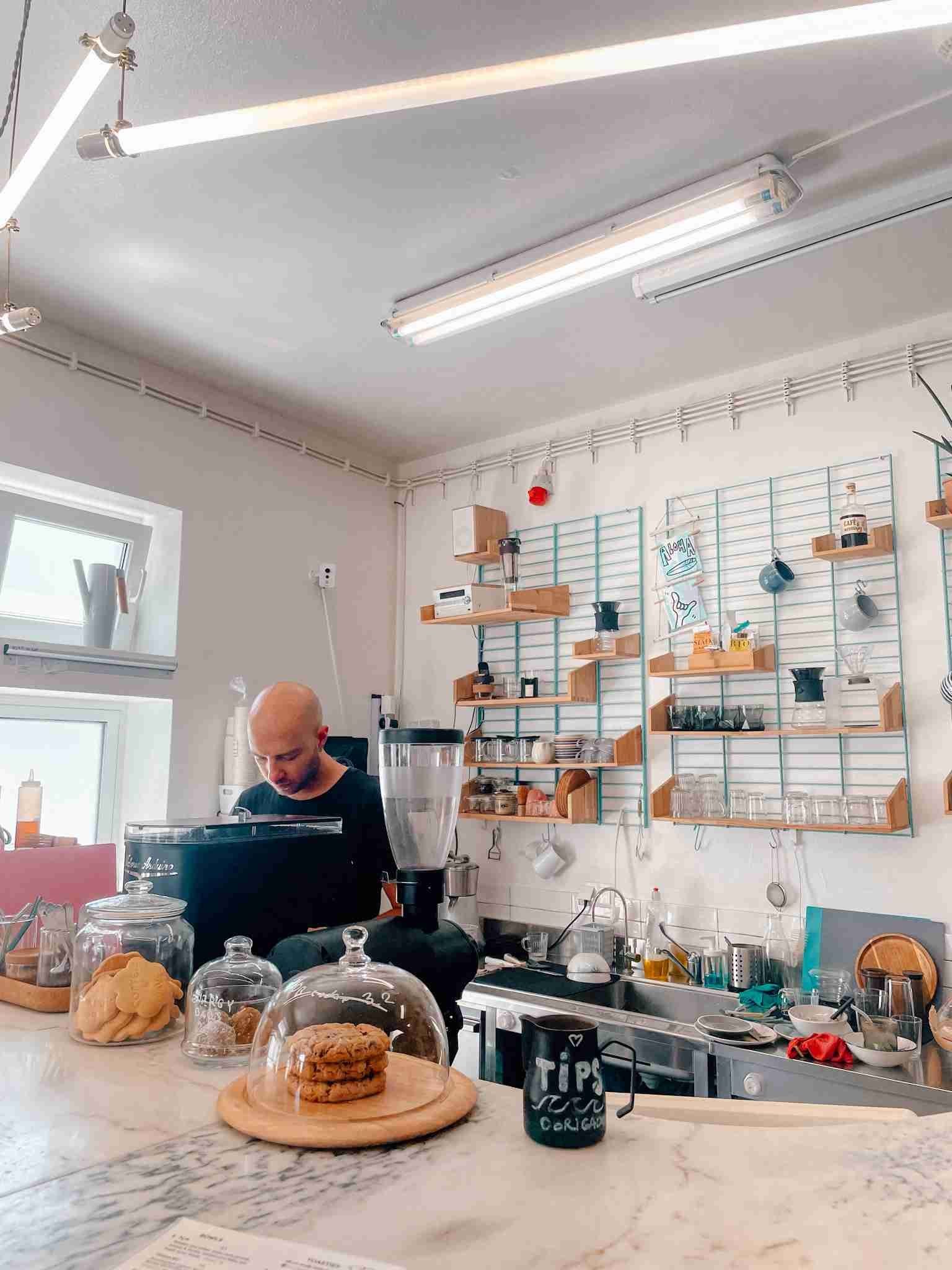 the barista hard at work inside the coffee and waves cafe