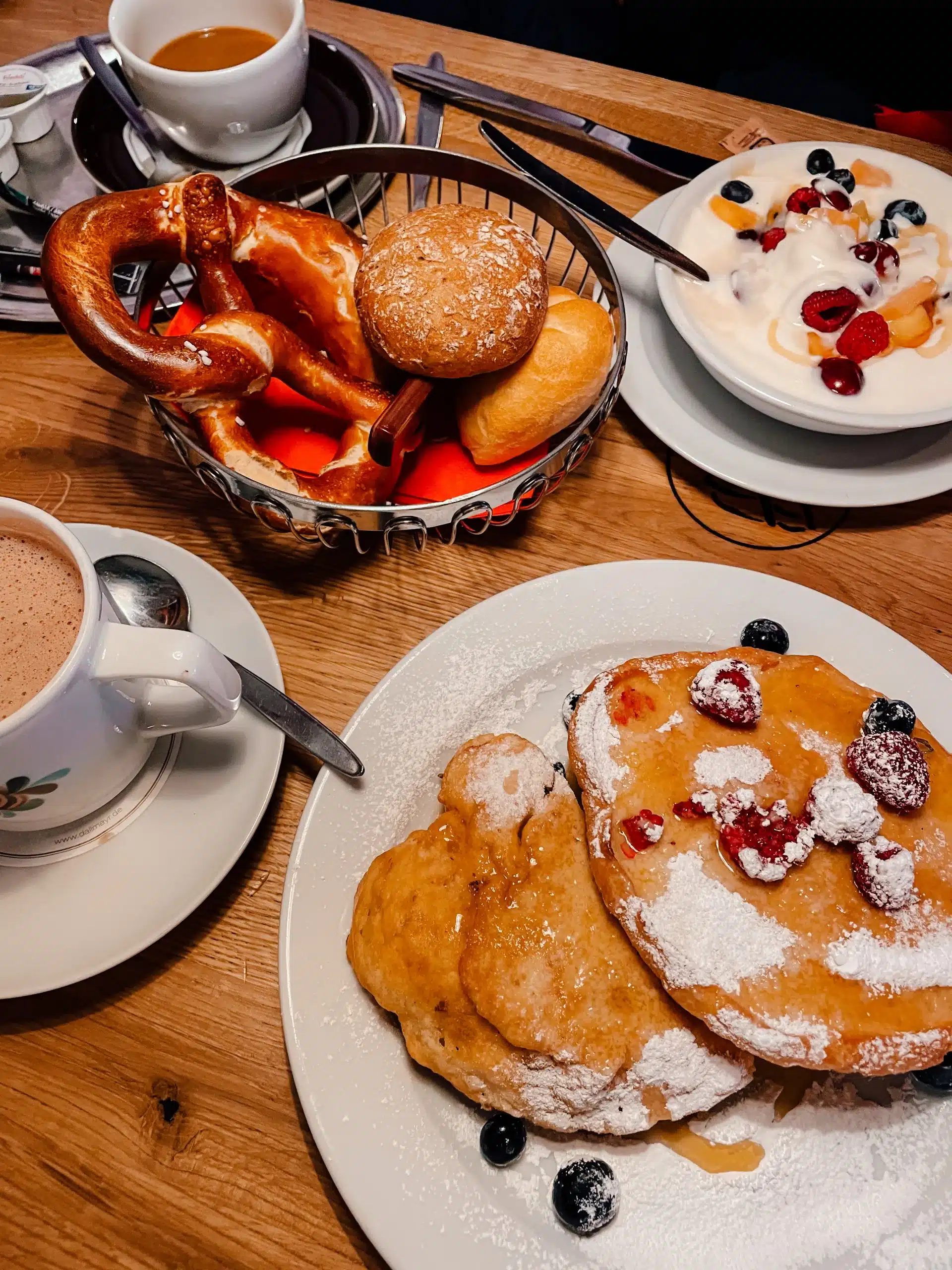 A table full with traditional Germany breakfast foods including pretzels!