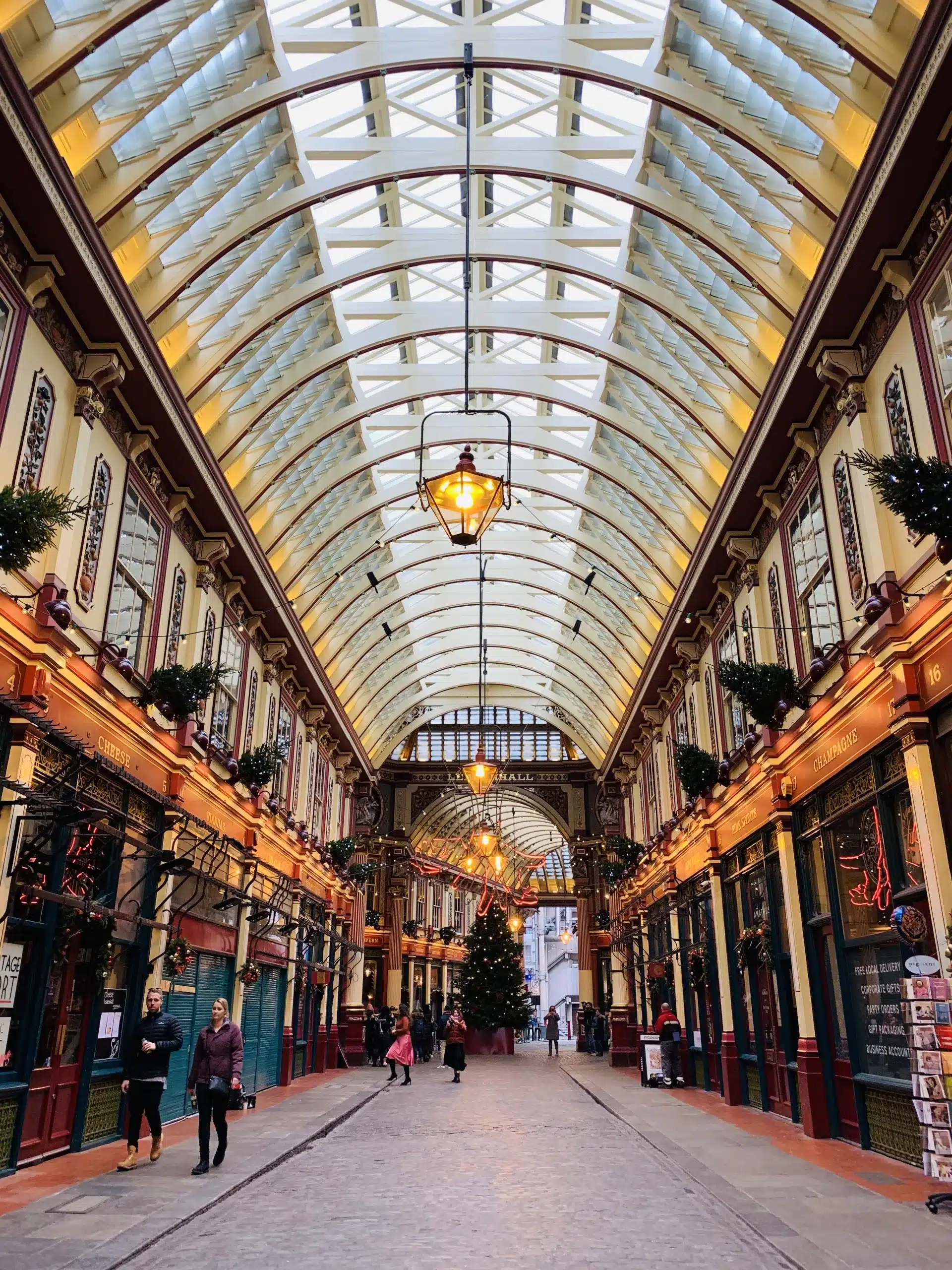 Beautifully decorated Christmas tree in Leadenhall Market, surrounded by festive garlands and twinkling lights