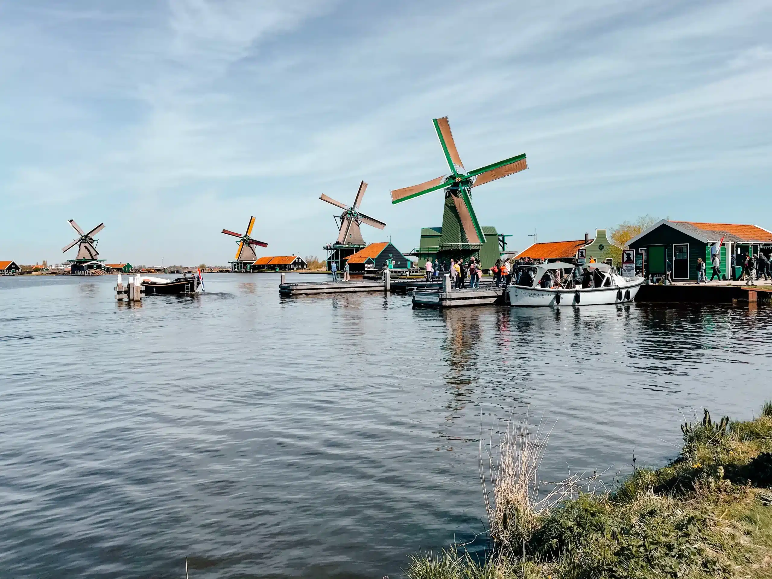A river lined with 4 differen traditional windmills at Zaans Schans