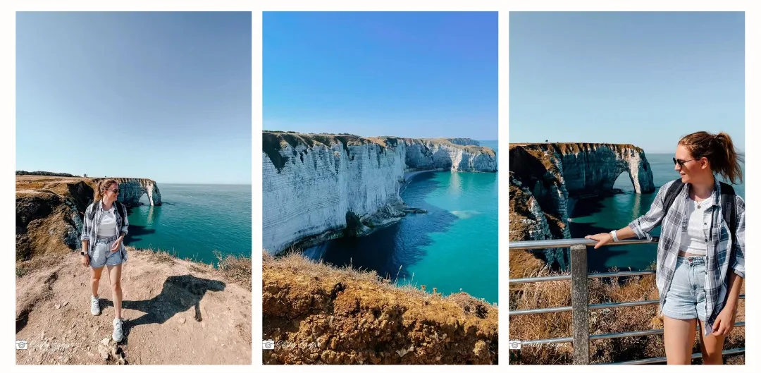 A girl is walking along the cliffs at Etretat with the iconic white rock arches in the background. The water is bright blue and she is admiring the steep clifs 