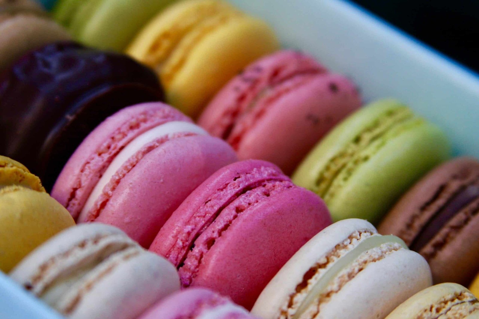Colourful macarons sit in a box