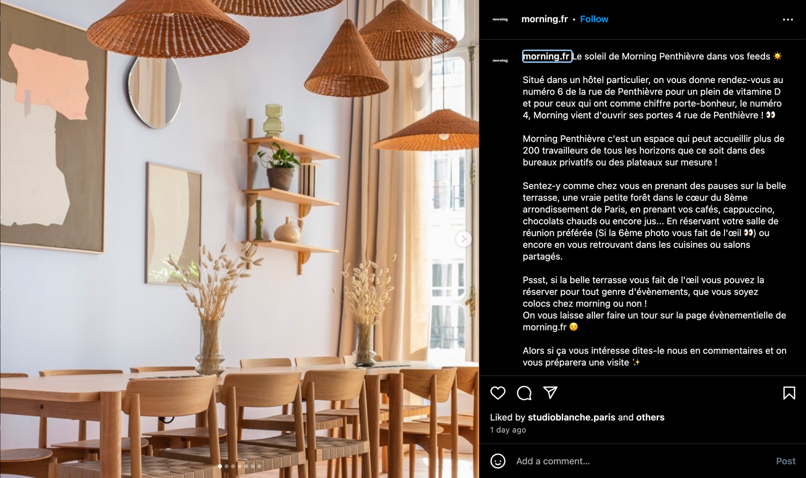 An aesthetic office of wood chairs and table with hanging lamps and simple art on the wall 