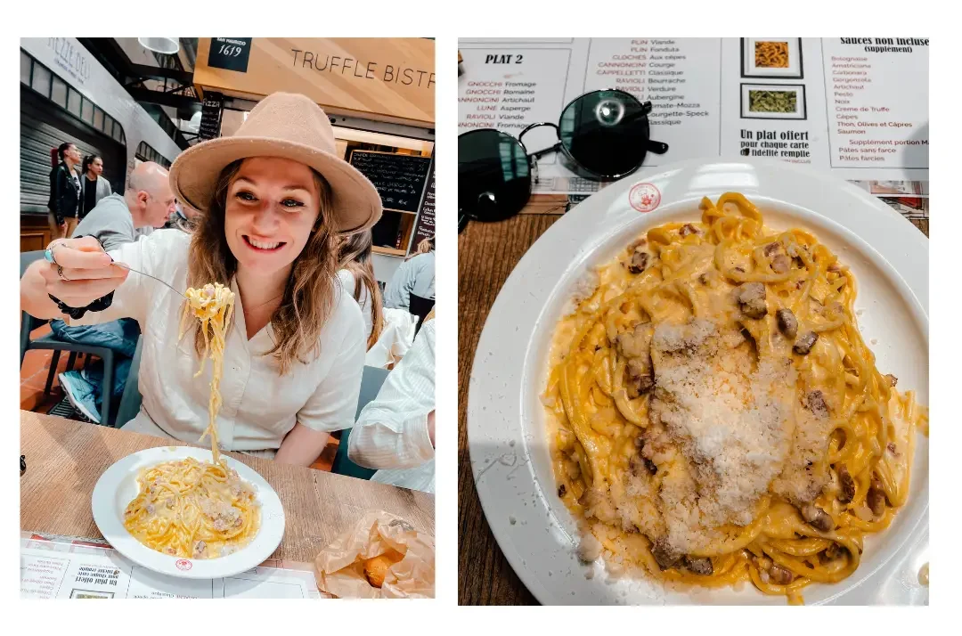 A girl sits pulling long strands of pasta from her plate smiling in delight