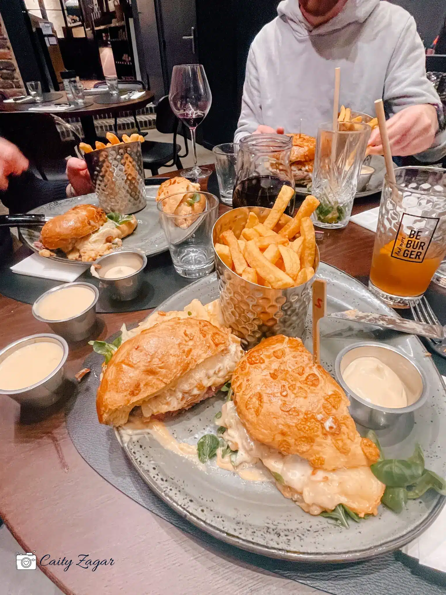 a massive burger with fries from Be Burger